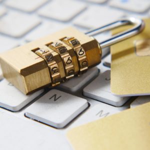 a golden padlock sitting on top of a keyboard